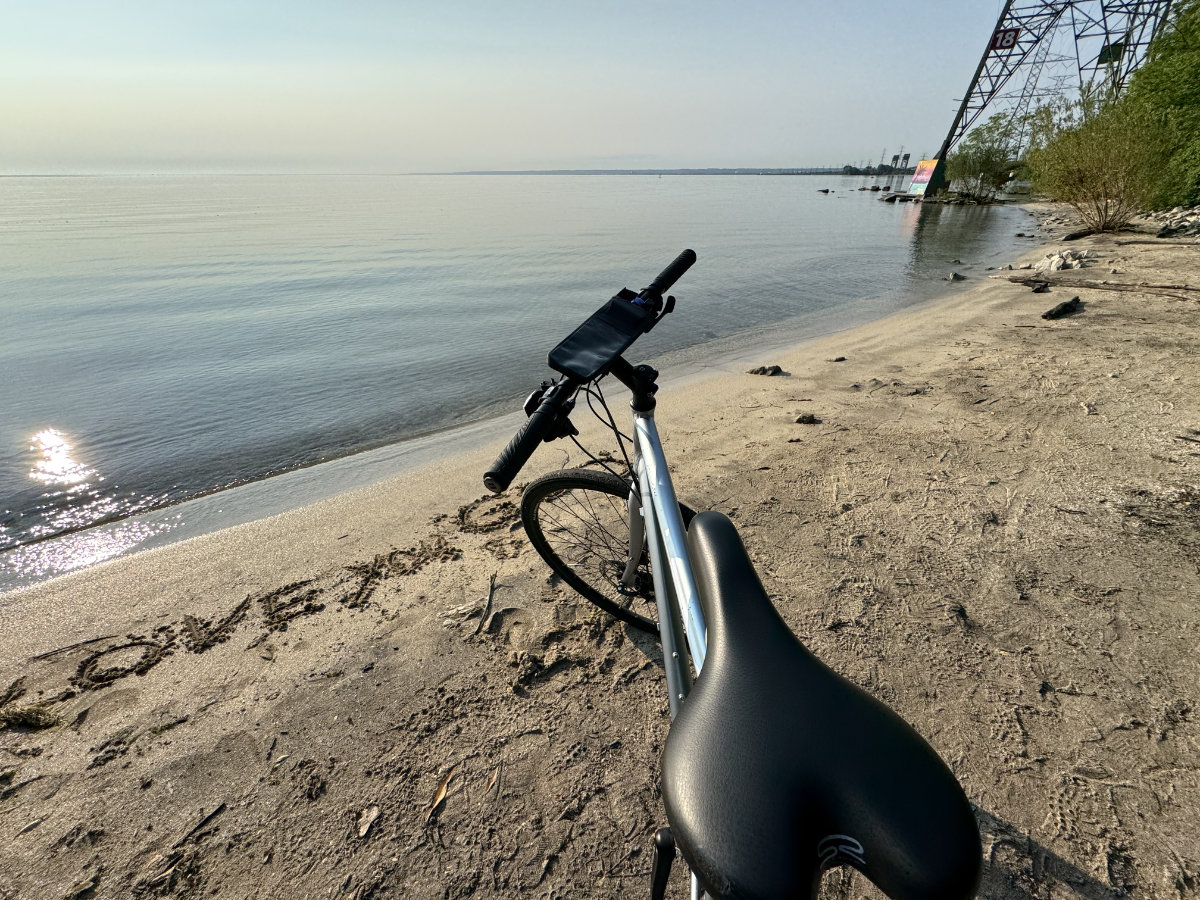 Mid bike ride, resting on the beach. I had nothing to do with the writing on the beach, and didn't realize it was there until looking at the photo later. Someone had a message for God.